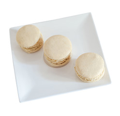 Coffee sweet macaroons, french traditional, cream,  white plate, close up, isolated on a white background