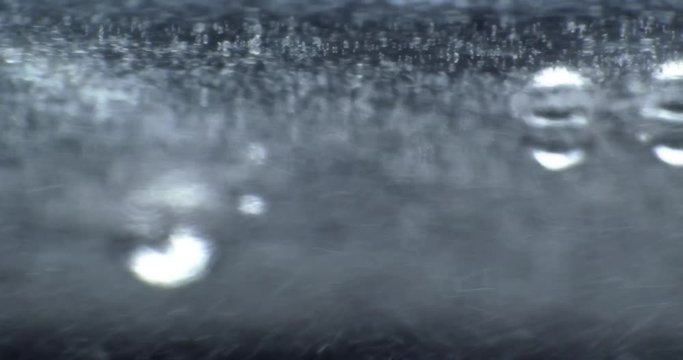 Oil drops floating in water over a colorful underground with oil painting effect.