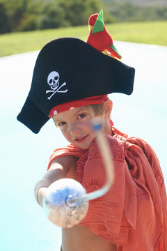 Portrait of boy in pirates hat, pointing toy sword