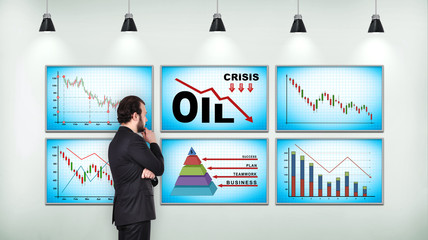 Businessman looking on chart of falling oil prices