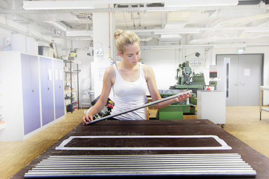 Technician working in mechanical workshop within optical laboratory