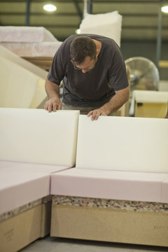 Upholsterer checking furniture box frame