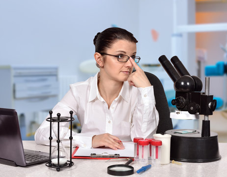 female scientist sitting in laboratory