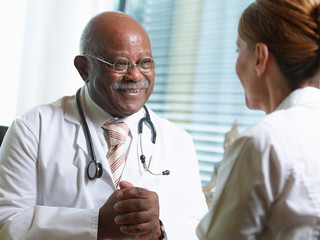 Senior doctor with female patient