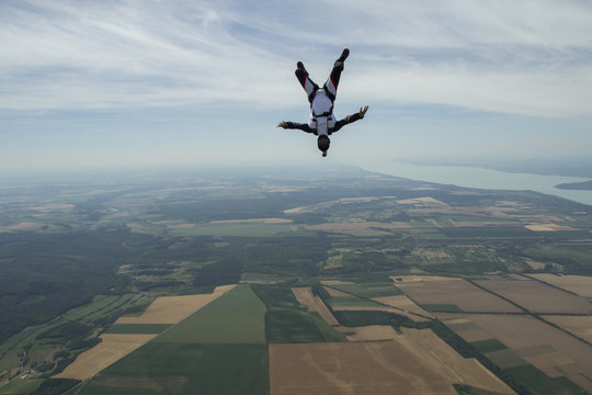 Male skydiver freeflying upside down above Siofok, Somogy, Hungary