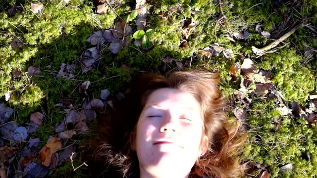 Girl lying in the moss