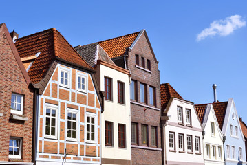 Fototapeta na wymiar Line of houses in the old town of Buxtehude, Germany. Hamburg, North Germany. Historical city with old houses. Old facades.