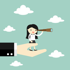 Business woman standing on the big hand and using her telescope looking for an opportunity. 