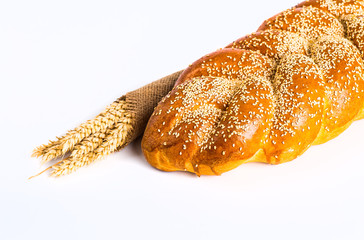 Sweet roll with poppy and sesame, isolated on white