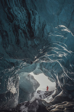 Man standing at ice cave entrance, Vatnajokull Glacier, Vatnajokull National Park, Iceland
