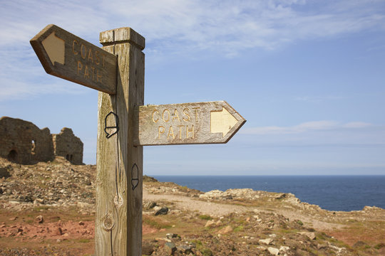 Naklejki Sign post and tin mine ruins on coastal path, Trewellard, Penzance, Cornwall, UK