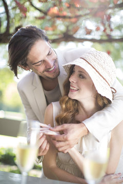 Couple getting engaged in garden restaurant