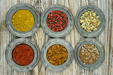 Spices and herbs in metal bowls. Food and cuisine ingredients.
