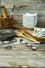 Different kitchen accessories from tin, olive wood and ceramic