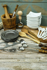 Different kitchen accessories from tin, olive wood and ceramic