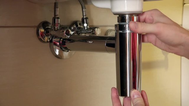 demonstration of unscrewing and removing the retaining ring but the siphon tube from the washing sink