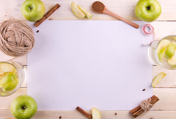 White background with apple and cinnamon drinks