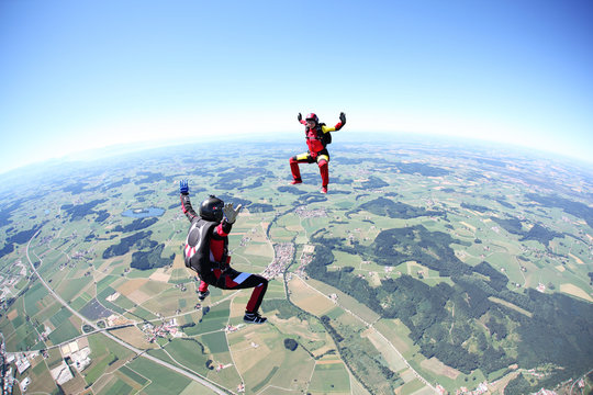 Skydivers having fun above Leutkirch, Bavaria, Germany