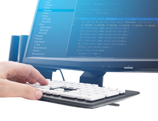 Developer working on source codes on computer at office