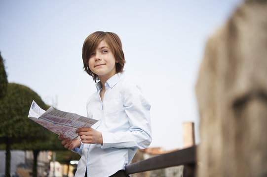 Young boy looking at map in park, Province of Venice, Italy