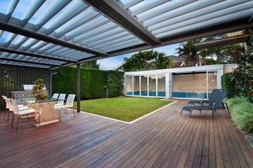 a beautiful courtyard with a lawn and swimming pool . barbecue area . - obrazy, fototapety, plakaty