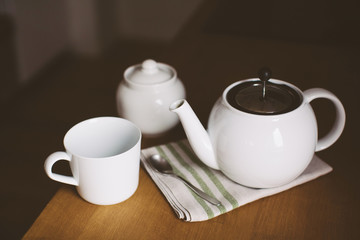 Cup, teapot on kitchen table