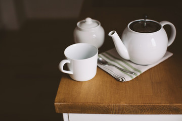 Cup, teapot on kitchen table