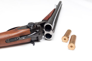 Shotgun with bullets on white background