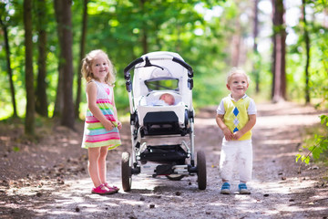 Children pushing stroller with newborn baby