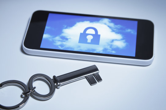 Secure smart phone. A key next to smartphone with a lock over a cloud on its screen.