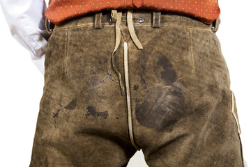 closeup of bavarian man wearing dirty leather pants