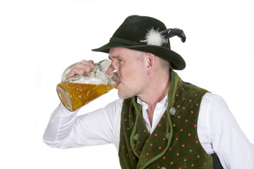 bavarian man drinking from a mug of beer
