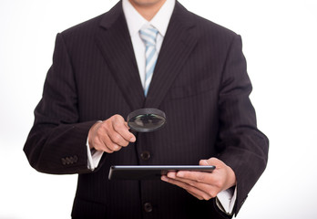 Auditor holding magnifying glass and tablet. Over blue background