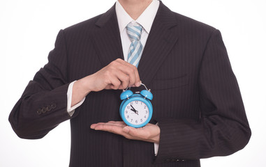 man with an alarm clock in a hand. Isolated on white background