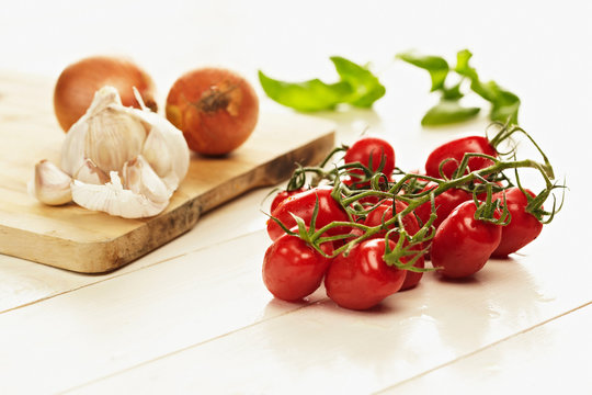 Cherry tomatoes, garlic and onion still life