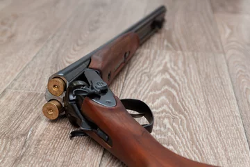 Fototapeten  retro gun with shotgun shells on wooden © Elena Sistaliuk