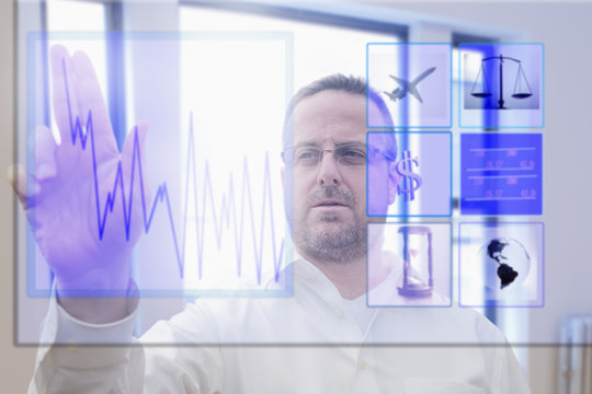 Mature man using interactive computer touchscreen
