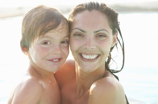 Portrait of mother and son in outdoor swimming pool