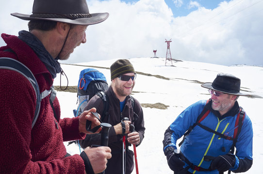 Three hikers in snow, Bucegi Mountains, Transylvania, Romania