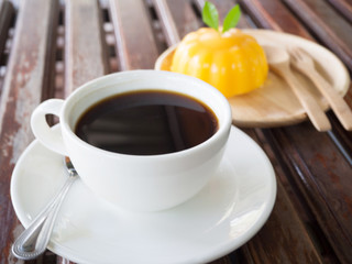 Cup of black coffee and orange cake