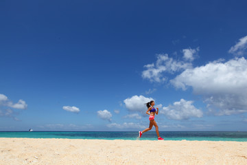 Fototapeta na wymiar Woman jogging on beach