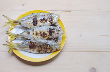 Grill Fish in dish on the wood table , Selected Focus