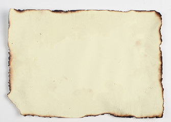 very old paper with burnt edges
