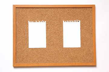 Cork board with paper note on white background