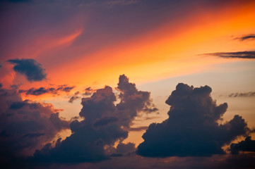 Black clouds in the sky and sunset colors 