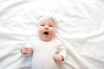 Little newborn girl lying on the bed 