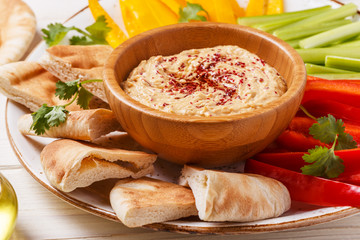 Homemade hummus with assorted fresh vegetables and pita bread.