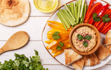 Homemade hummus with assorted fresh vegetables and pita bread.