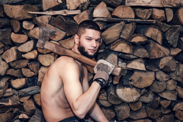 Man with an ax near firewood stock