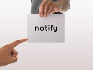 a man using hand holding the white paper with text notify